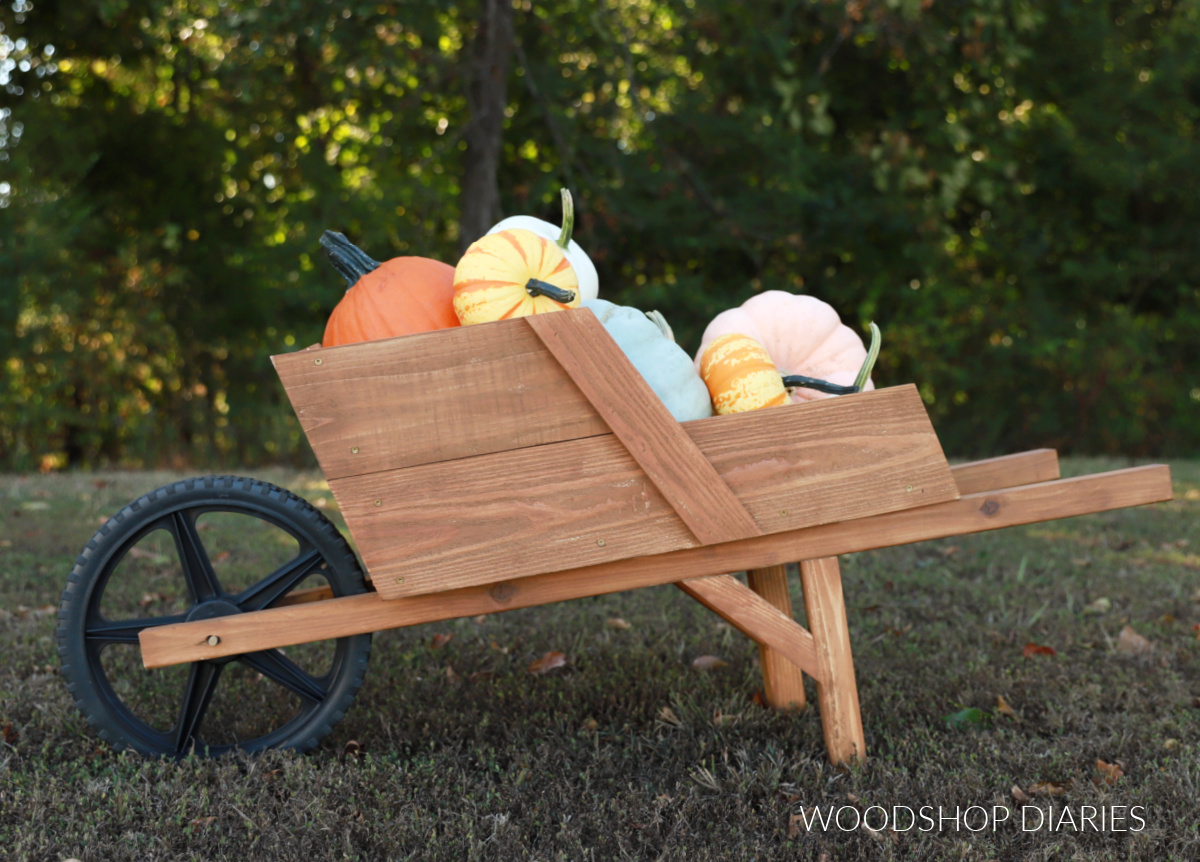 Wooden DIY wheelbarrow filled with pumpkins