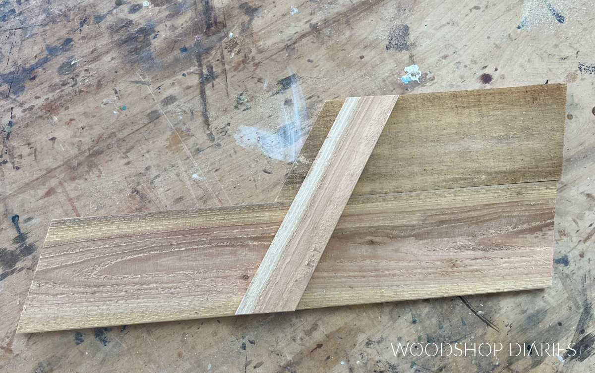 wheelbarrow side panel pieces cut from cedar fence picket laying on workbench