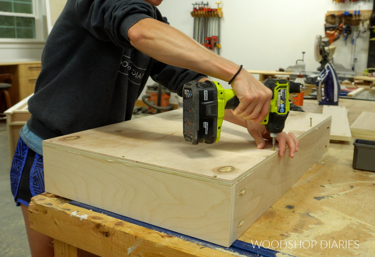 Shara Woodshop Diaries screwing bottom panel onto drawer boxes