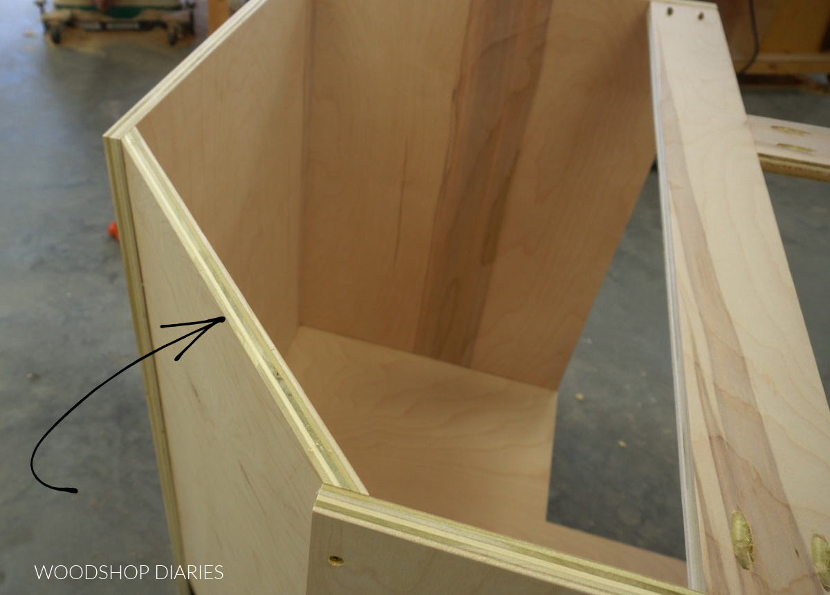 Angled back panel installed into corner cabinet closet up from top view