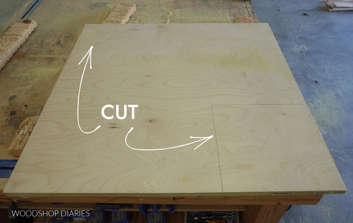 Corner base cabinet bottom panel on workbench with markings where to cut