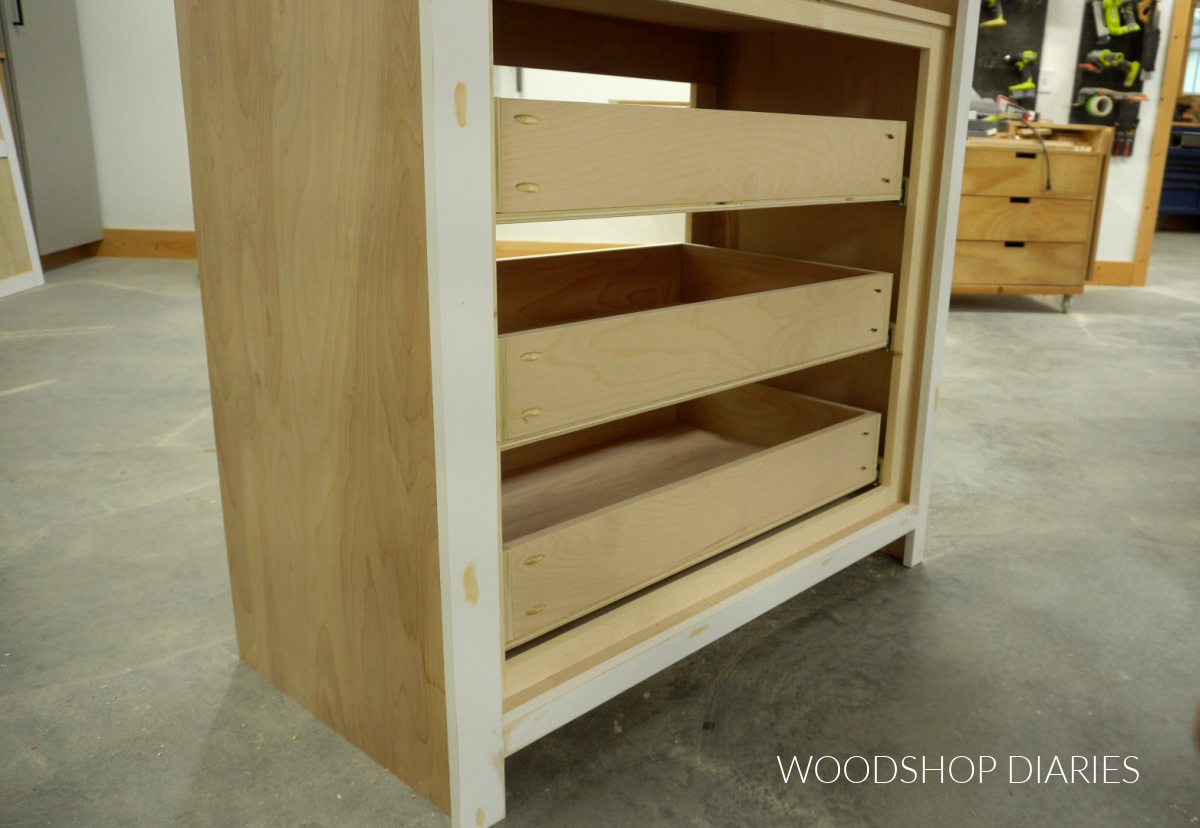 Drawer boxes installed into bottom section of tall kitchen cupboard
