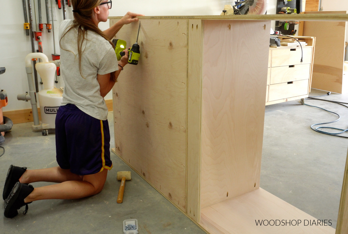 Shara Woodshop Diaries installing back panel onto tall larder cabinet