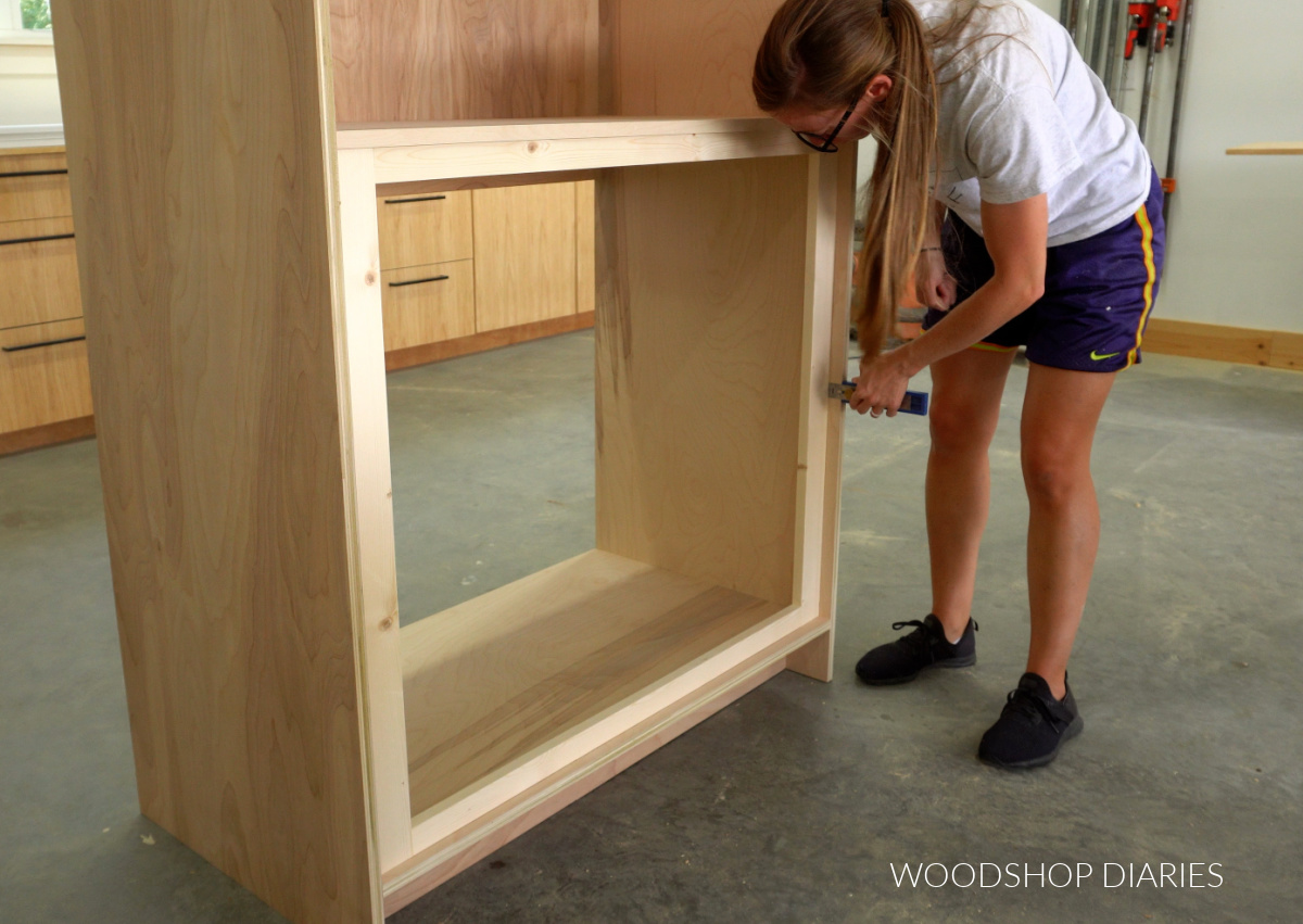 Shara Woodshop Diaries placing interior face frame into bottom section of kitchen cupboard