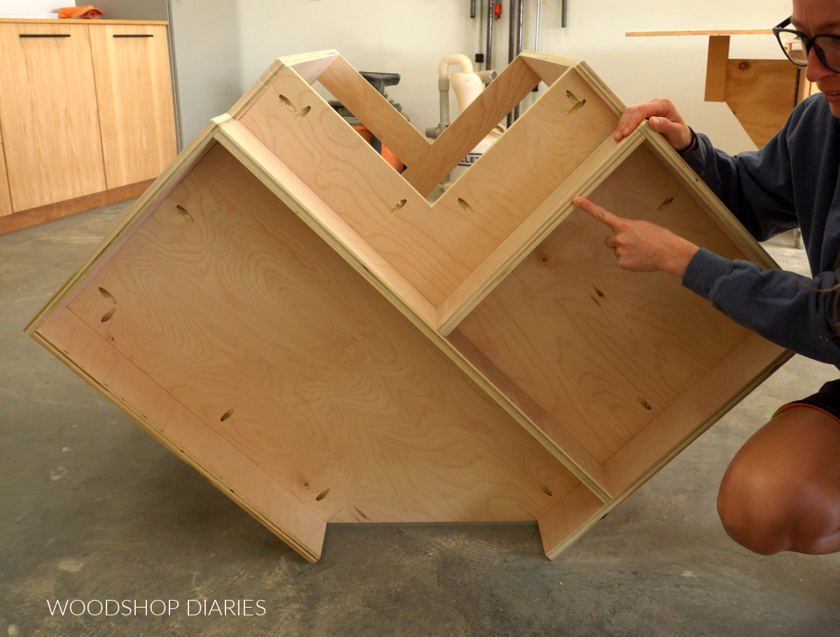 DIY Corner cabinet turned on its back revealing toe kick backers installed under bottom panel