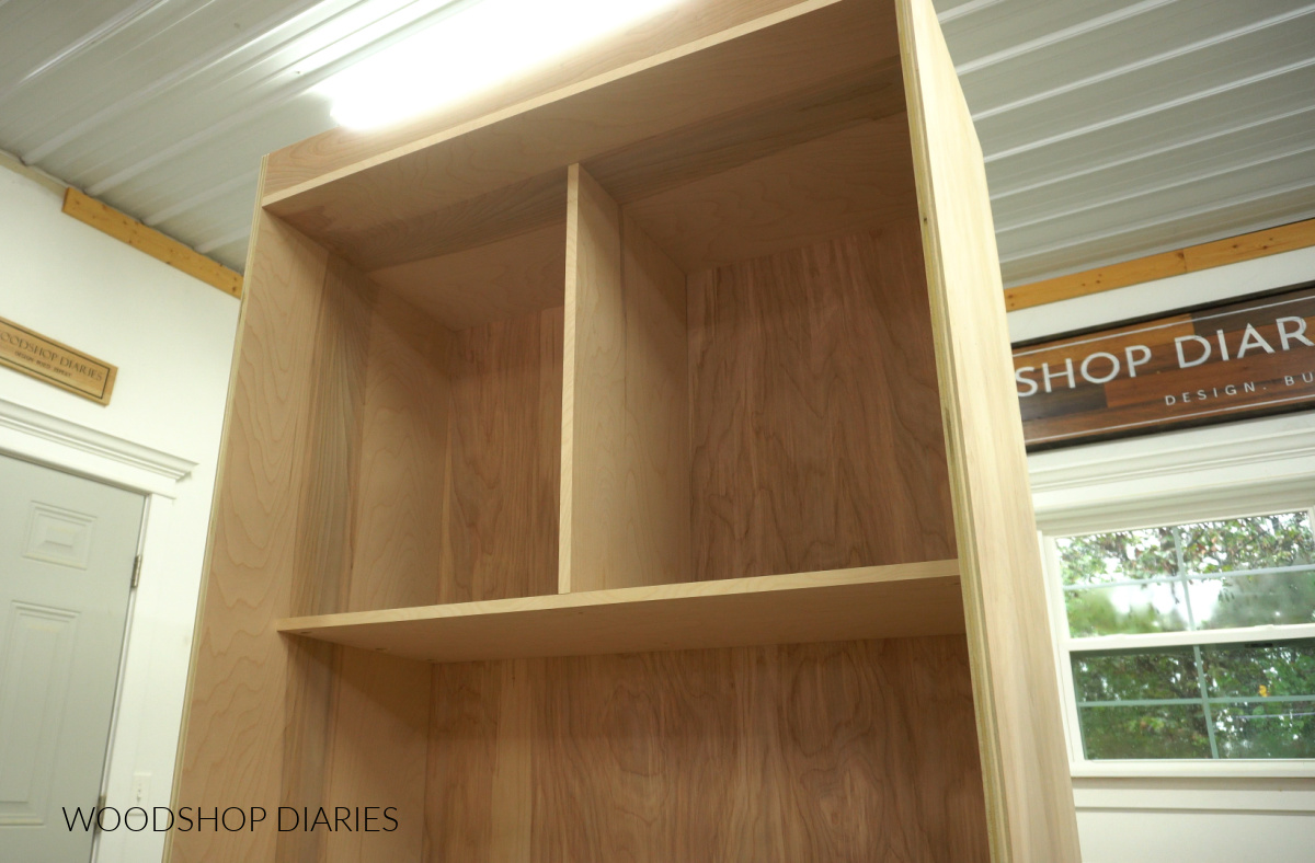 Shelves installed into top section of larder cabinet
