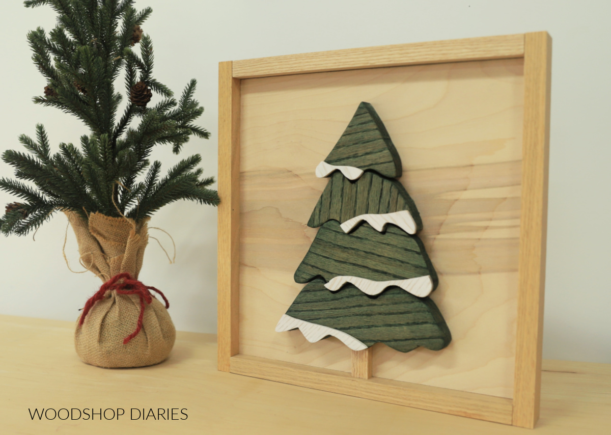 Scrap wood art sign of tree with snow on branches