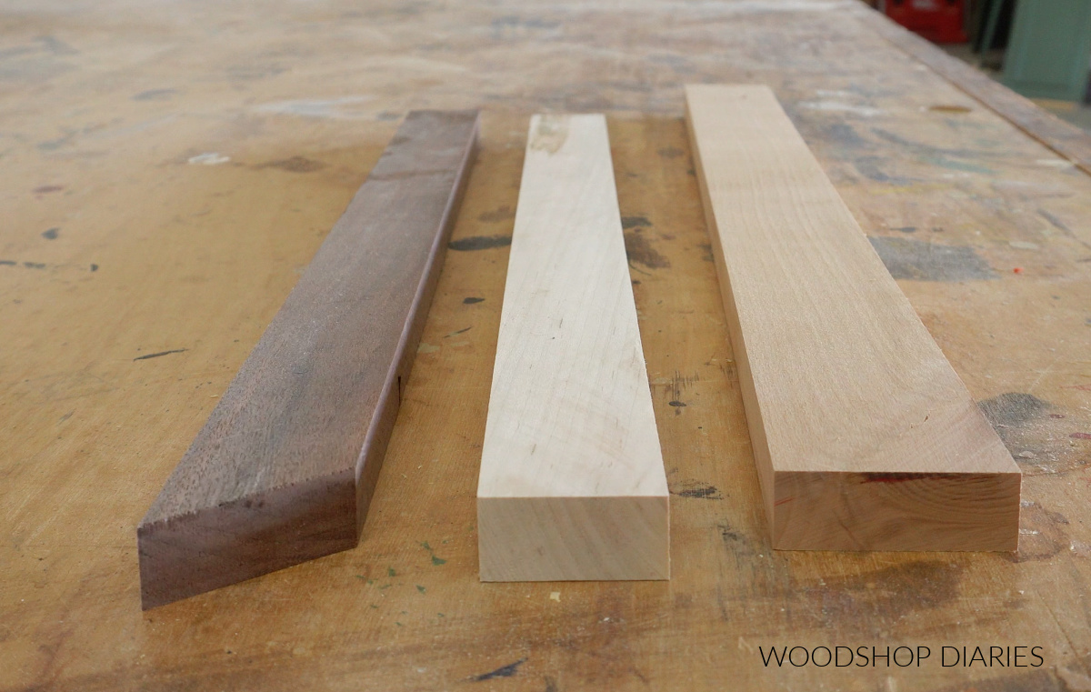 walnut, maple, and alder boards laying on workbench