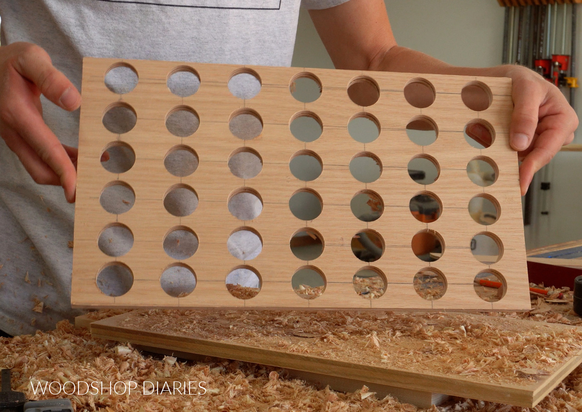 holes drilled in ¼" plywood panels for 4 in a row game board