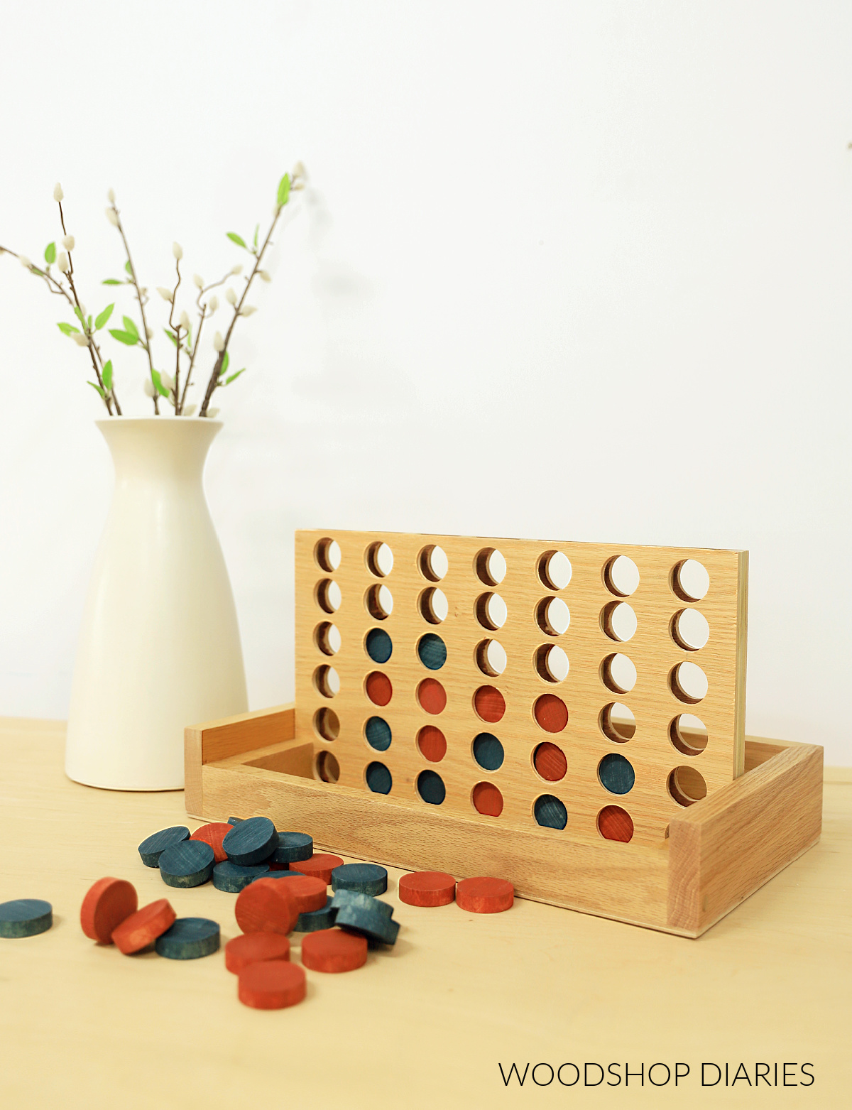 Finished DIY 4 in a row connect game made from plywood and wooden dowels with red and blue game pieces