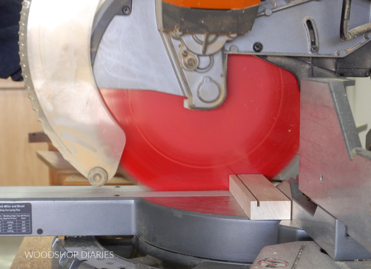 Cutting DIY desktop photo frame bottom piece with miter saw