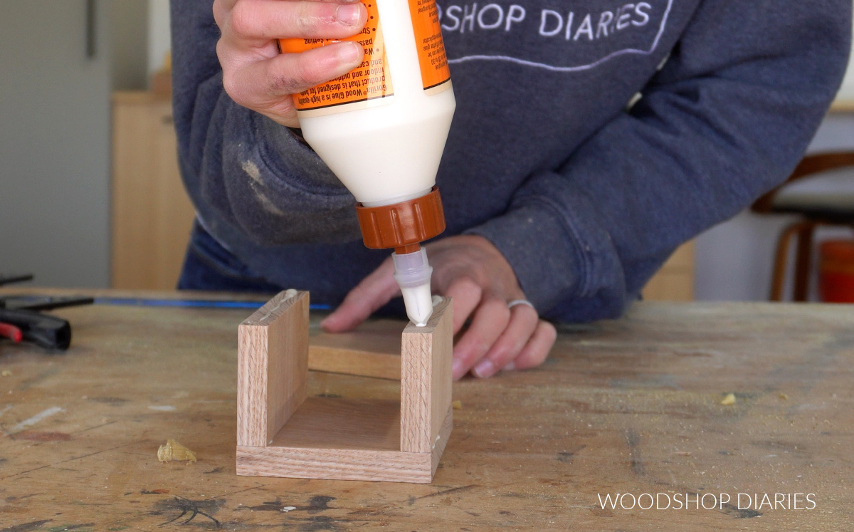 Shara Woodshop Diaries gluing pieces of pencil holder together on workbench for organizer tray