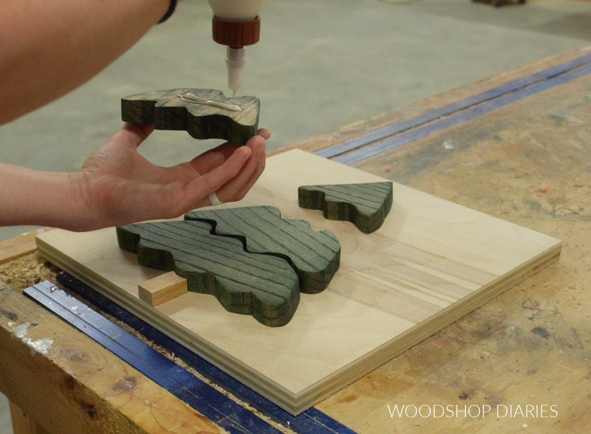 Shara Woodshop Diaries applying glue to back side of christmas tree pieces