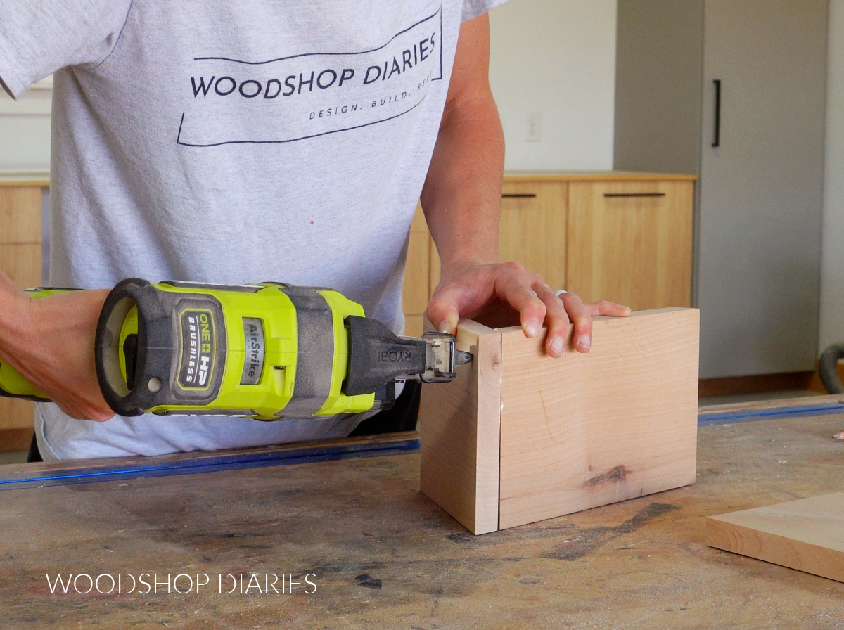 Shara Woodshop Diaries brad nailing board together to make book holder