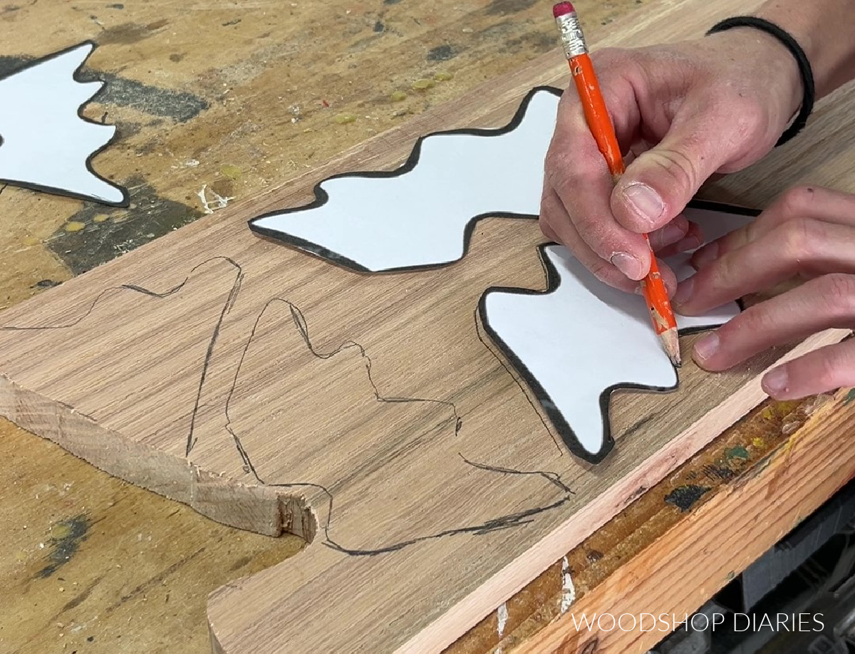 Shara Woodshop Diaries tracing Christmas tree shapes onto red oak board