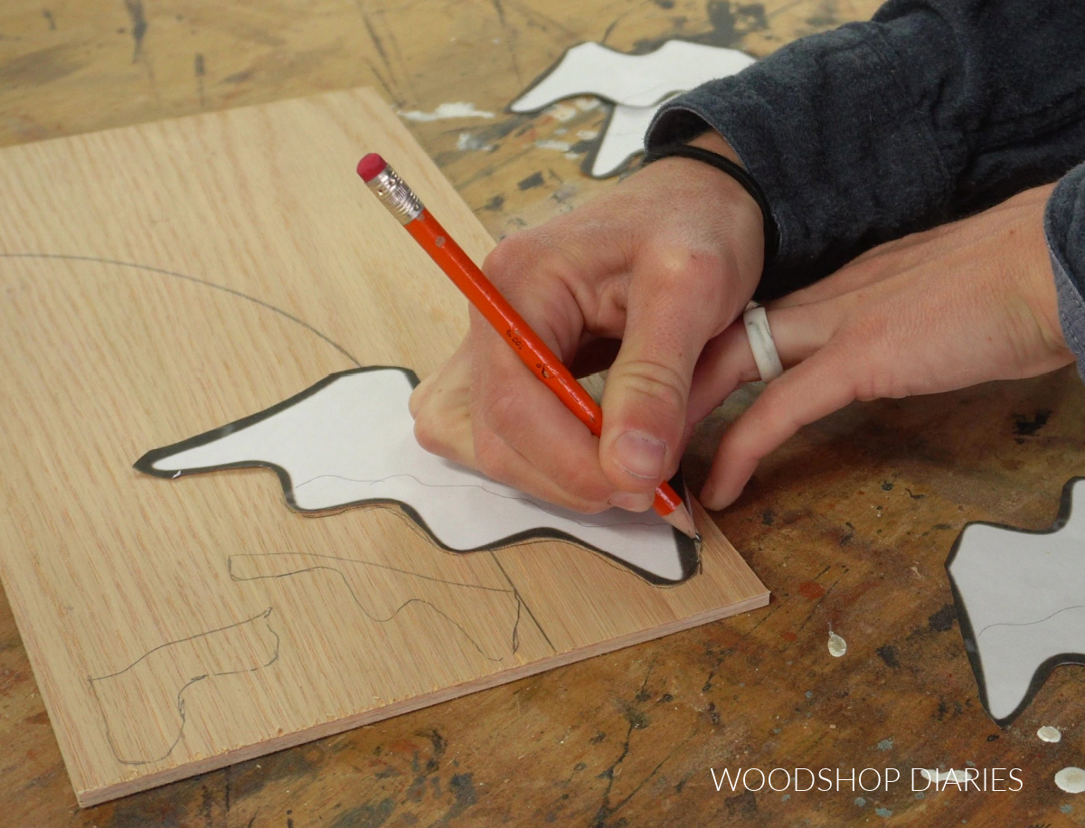 Shara Woodshop Diaries tracing around bottom edge of tree templates on ¼" plywood 