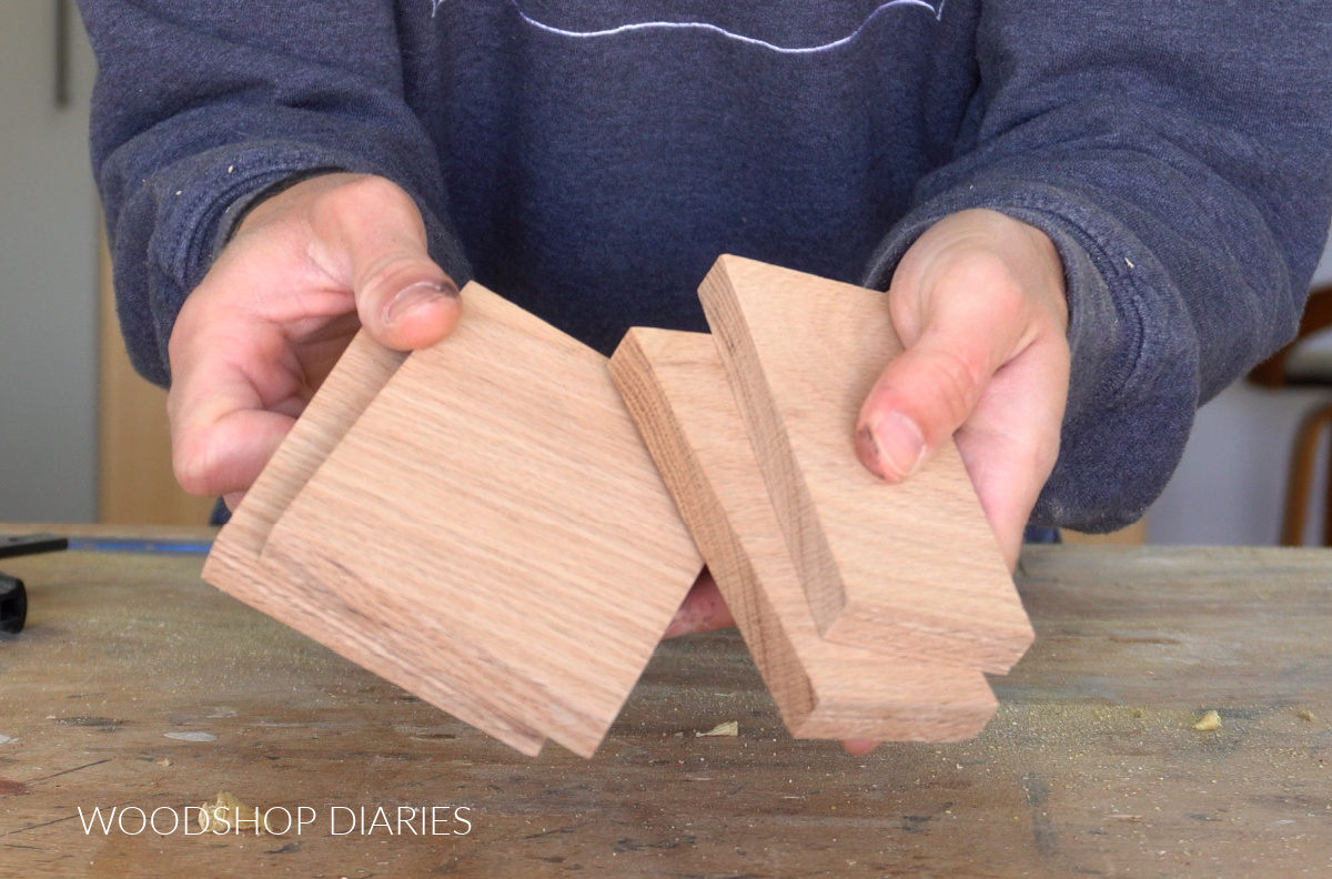 Shara Woodshop Diaries holding pieces of ½" thick red oak lumber cut to small pieces