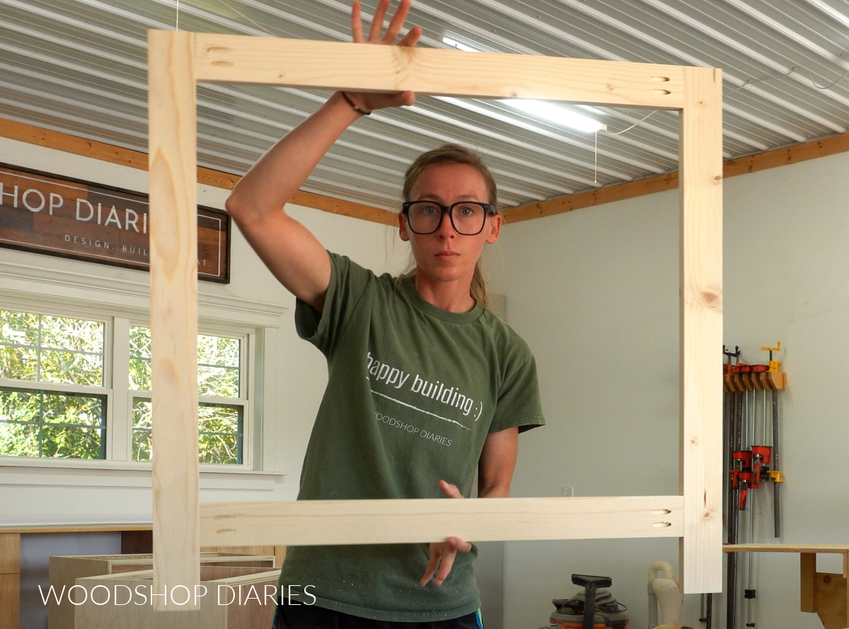 Shara Woodshop Diaries holding face frame for office built in cabinets