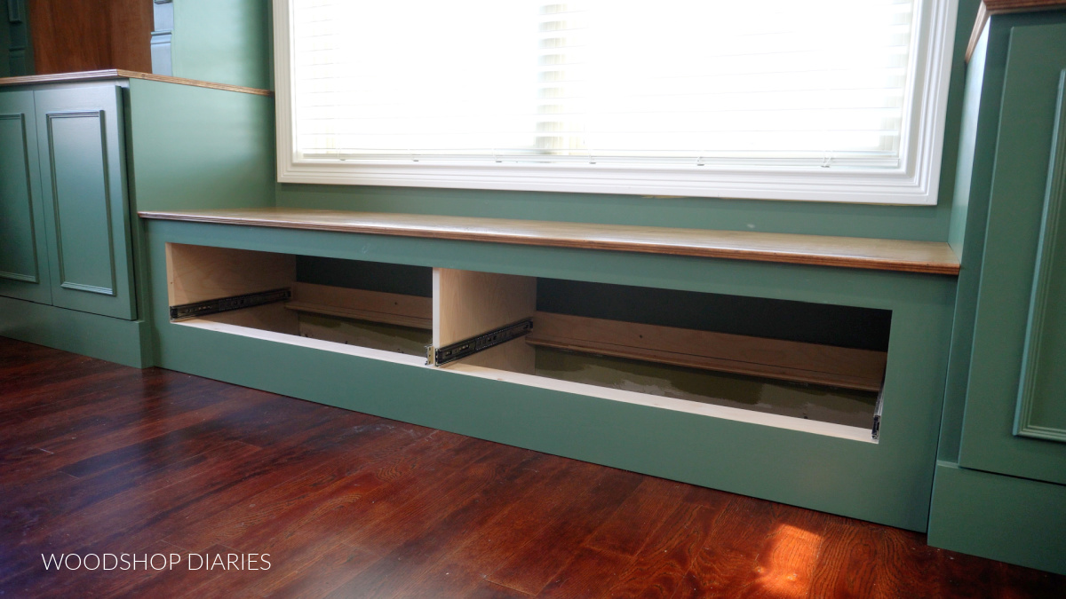 Bench seat installed between base cabinet built ins with drawers removed