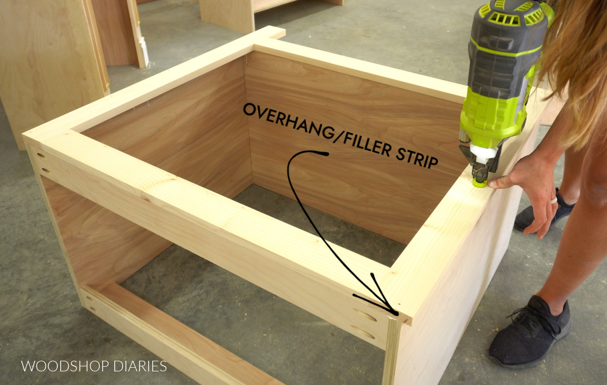 Shara Woodshop Diaries nailing face frame onto front of cabinet on workshop floor