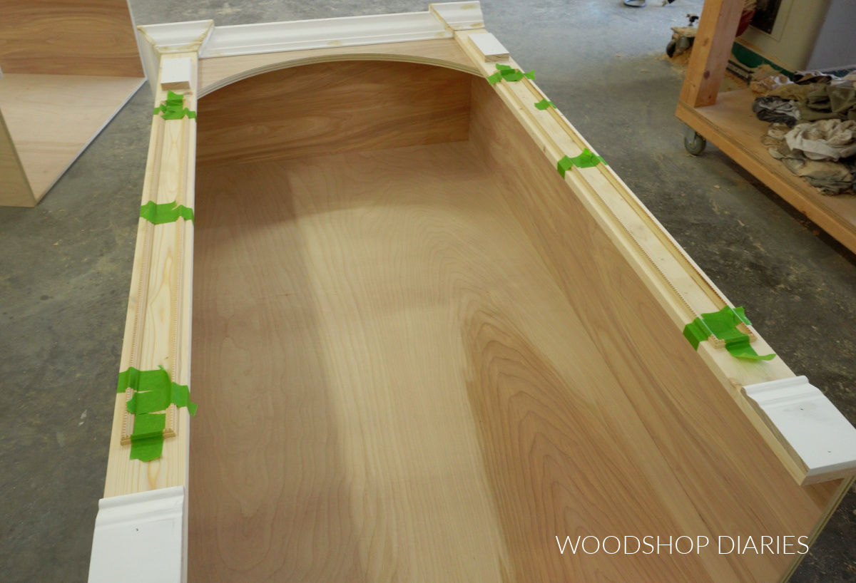 Molding detail added to front of DIY built in bookcase cabinets