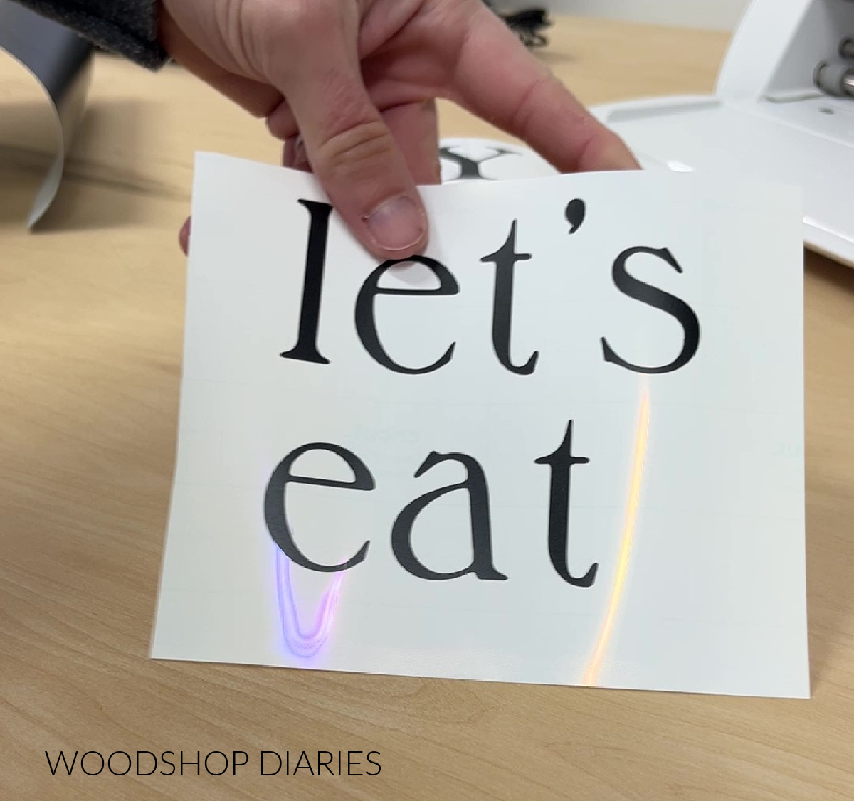 Close up of one of the stencils with just the lettering reading "let's eat"