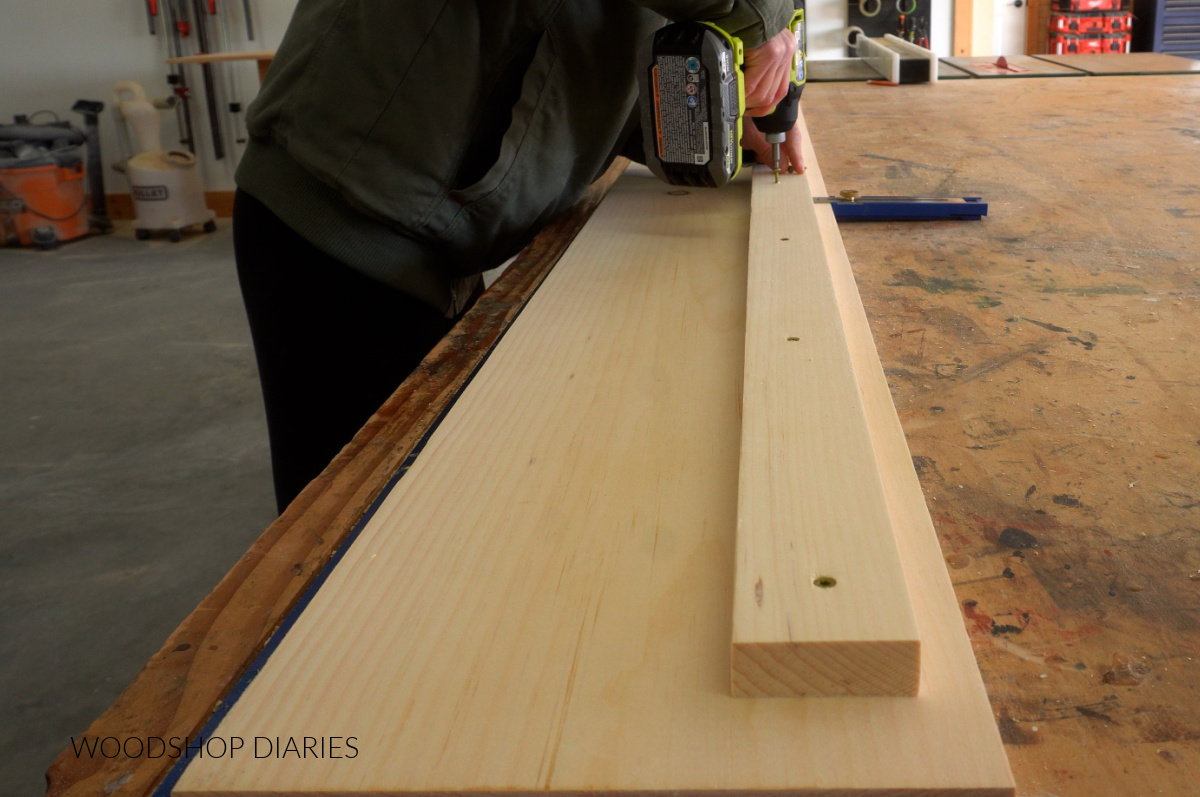 Shara Woodshop Diaries screwing bed rail support to side rail on workbench