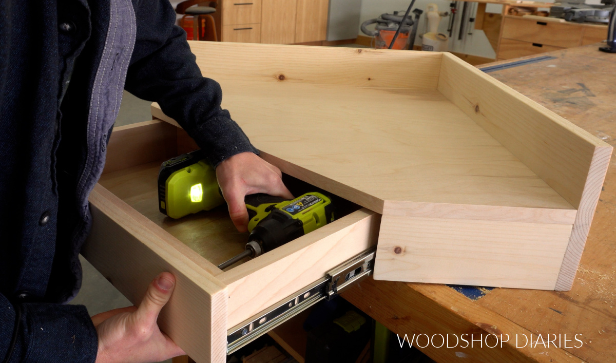 Securing drawer front onto drawer of corner desk