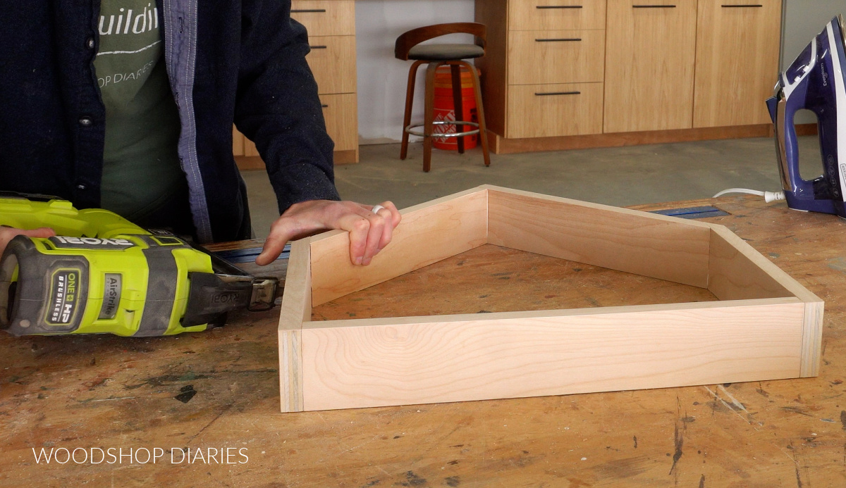 Shara Woodshop Diaries nailing drawer box together on workbench
