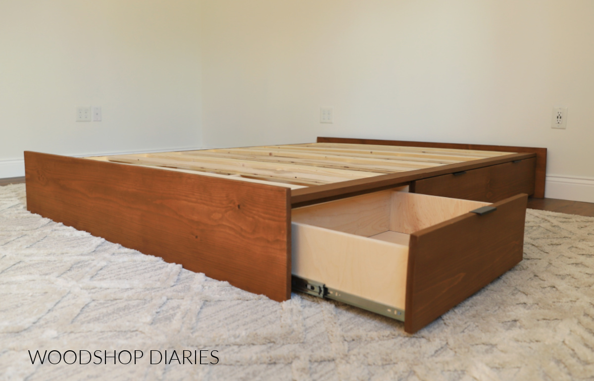 Platform storage bed with drawers--one drawer open--assembled in room without mattress 