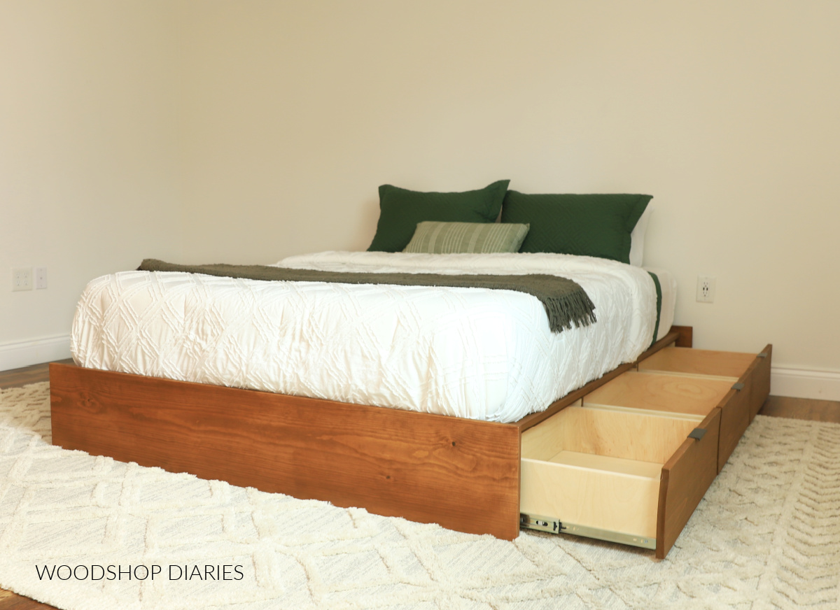 DIY finished storage bed frame with three drawers open on one side
