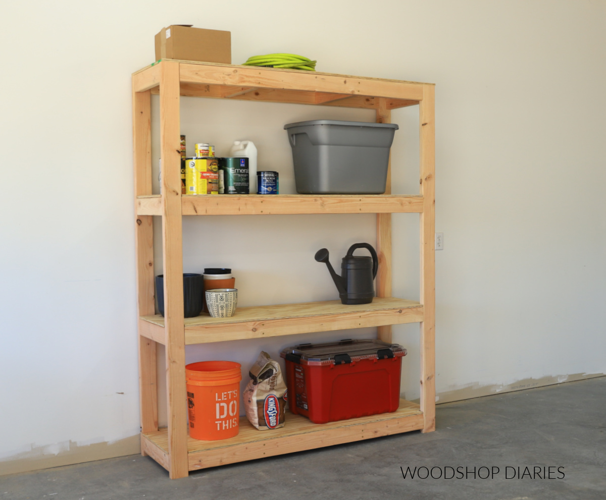 Heavy Duty DIY Freestanding Garage Shelving Unit with totes and items stored on each of the 4 tiers