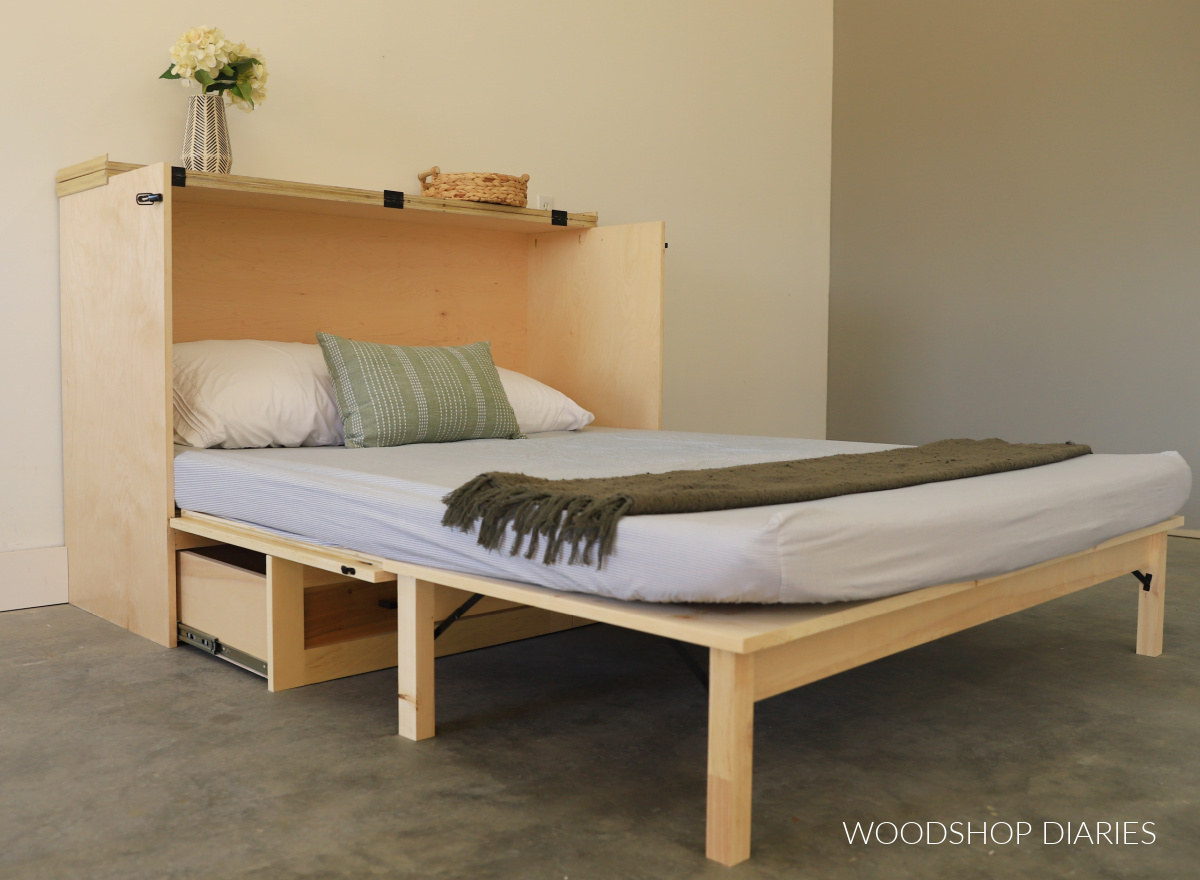 DIY murphy bed cabinet folded out into a bed with trifold mattress laid out on top