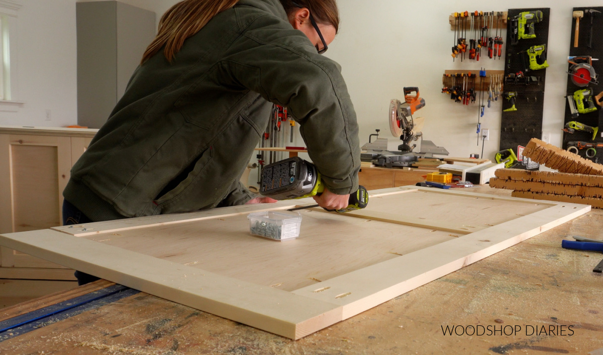 Shara Woodshop Diaries installing ½" plywood panels into 1x4 frame on workbench