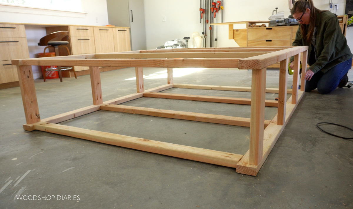 Shara Woodshop Diaries assembling shelf sides on workshop floor