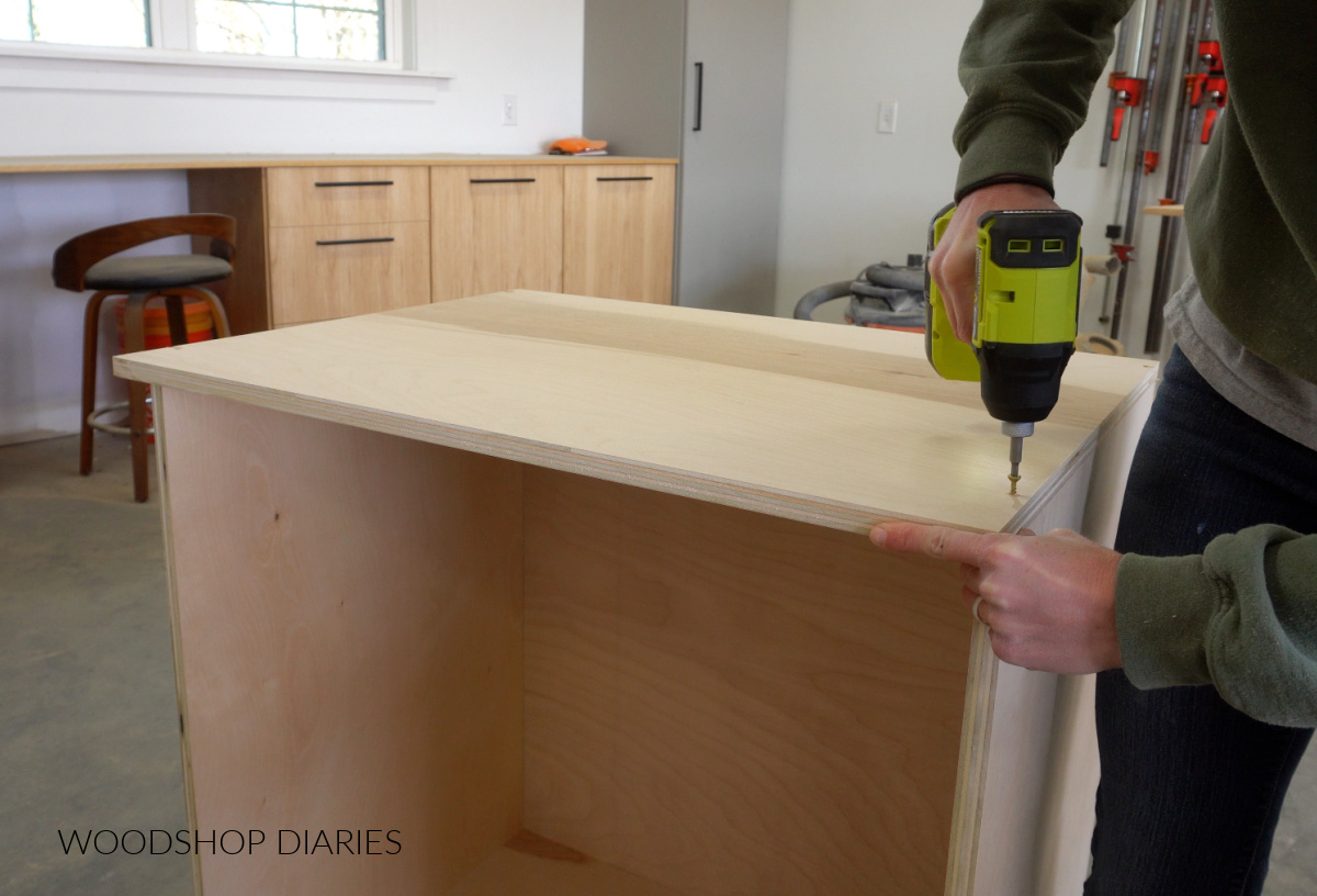 Shara Woodshop Diaries securing cabinet top with screws from the top side
