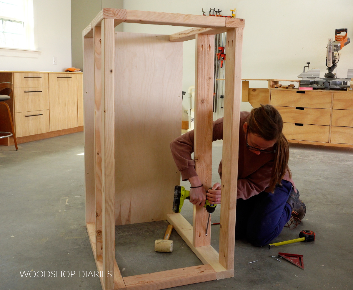 Shara Woodshop Diaries installing shelf framing on workbench build with pocket hole screws