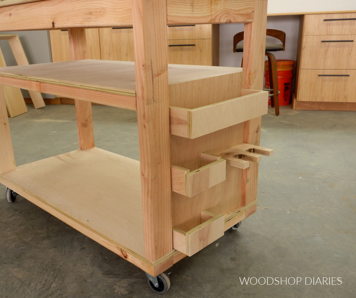DIY mobile workbench side panel with storage cubbies and a tool holder installed
