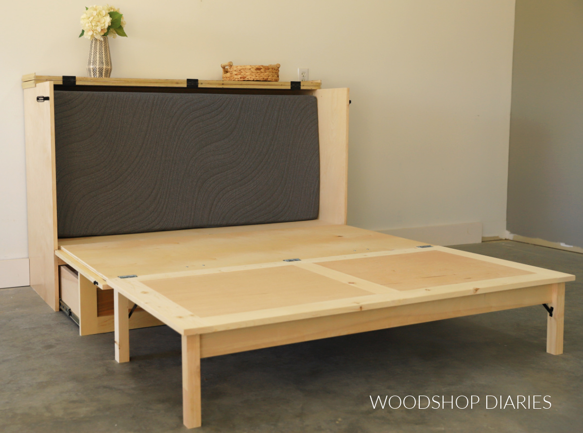 DIY murphy bed cabinet opened up with tri fold mattress tucked inside cabinet