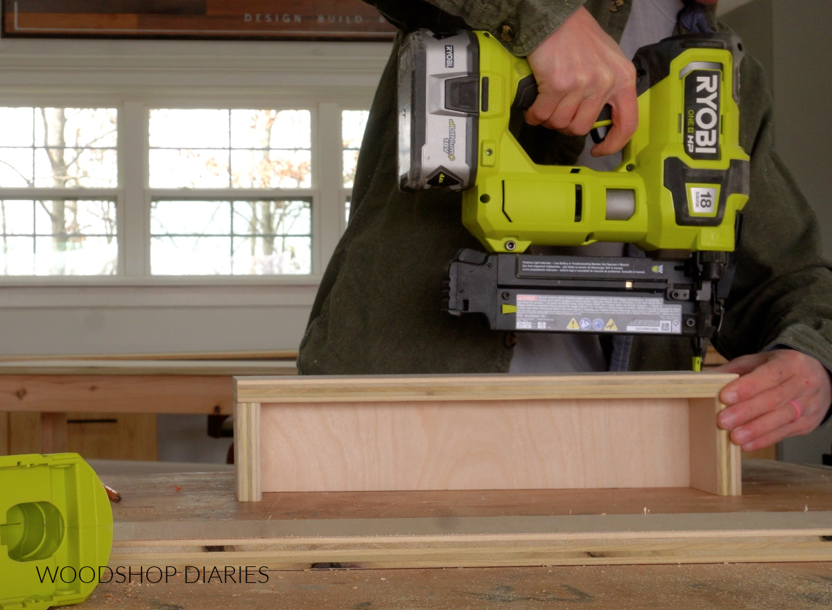 Shara Woodshop Diaries nailing storage cubbies together on workbench 