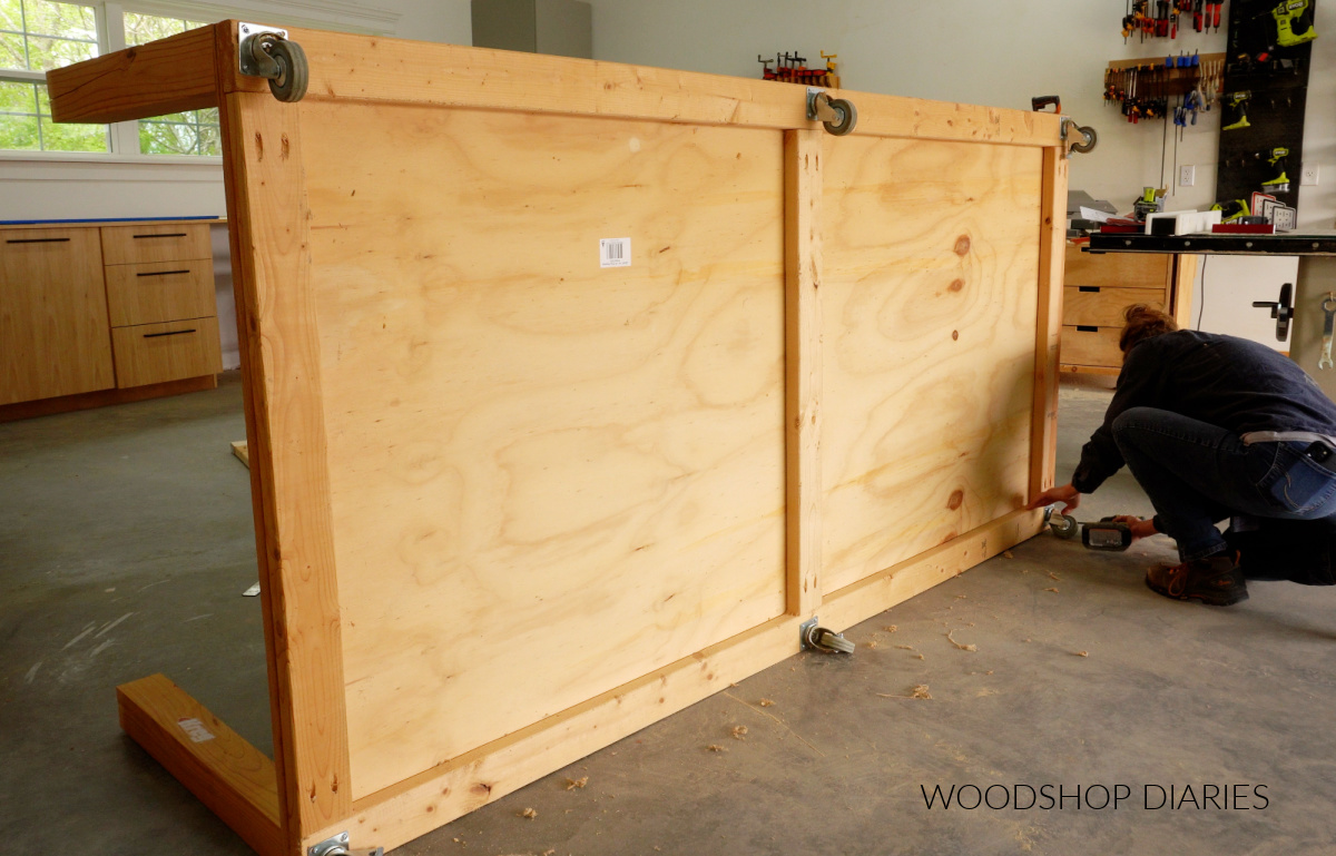 Shara Woodshop Diaries installing caster wheels to bottom of workbench frame