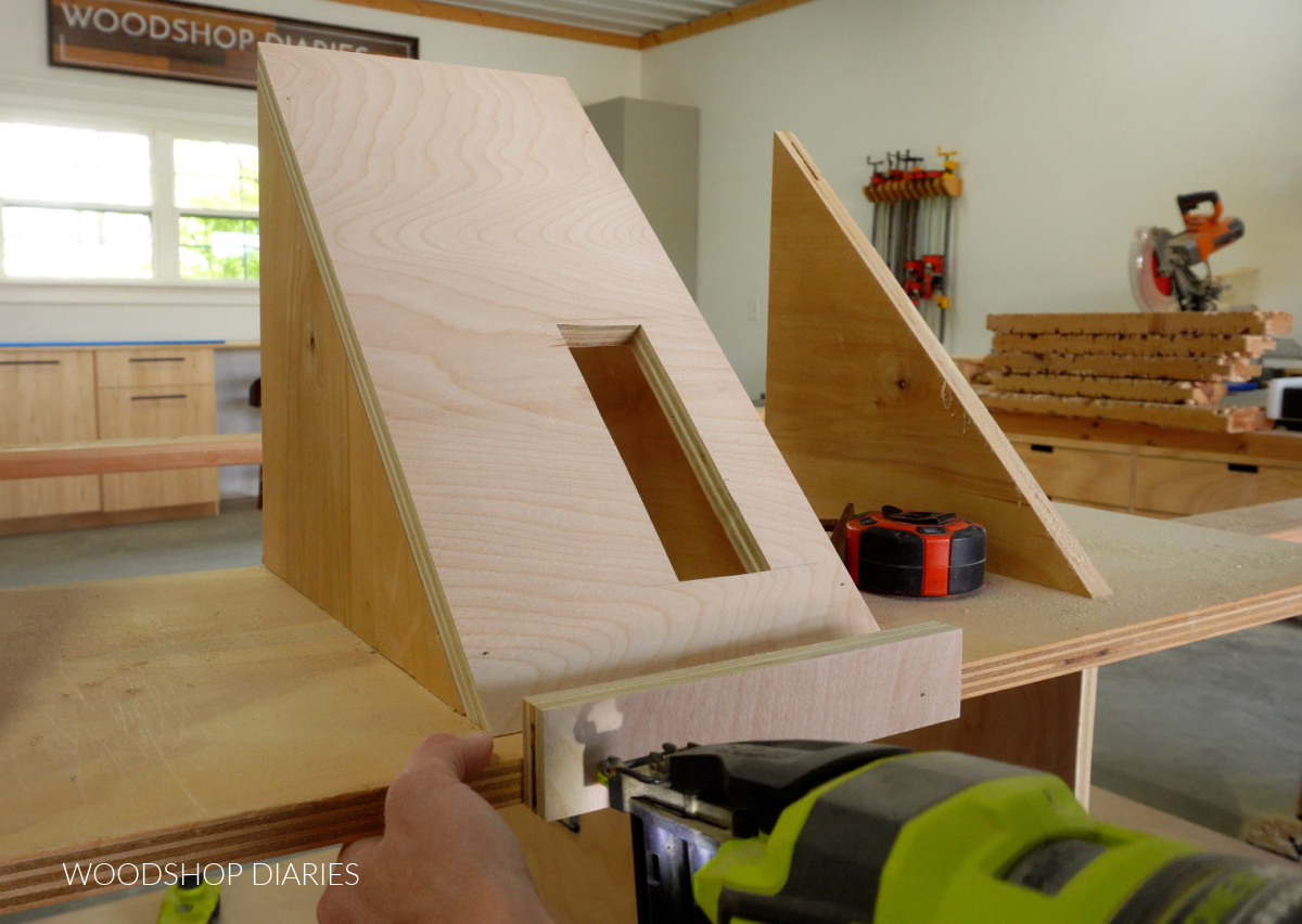 Nailing custom fit plywood pieces to hold circular saw on workbench shelf