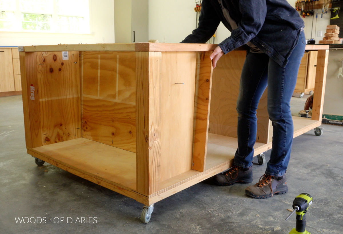 Shara Woodshop Diaries placing divider panel up to side panels in workbench frame
