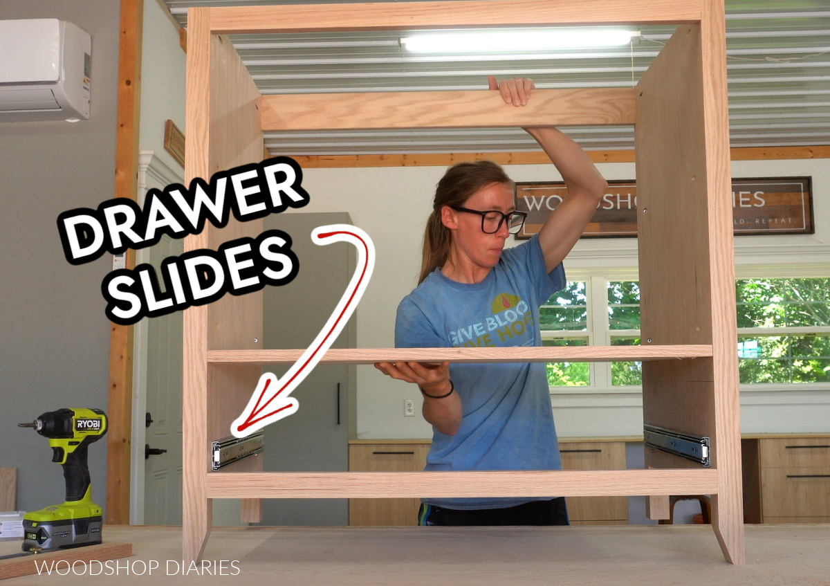 Shara Woodshop Diaries flipping over bathroom vanity frame on workbench with drawer slides installed