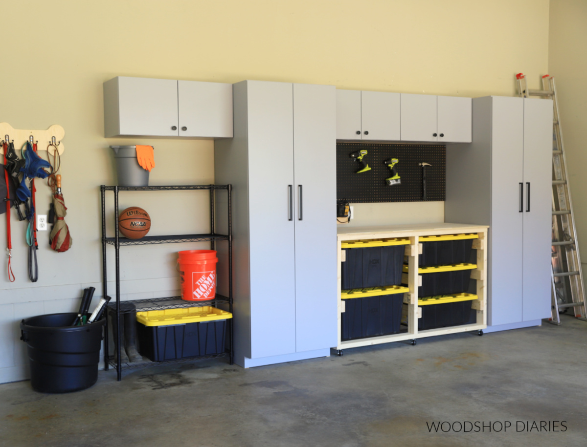 Completed DIY garage cabinets with storage tote workbench and shelving unit
