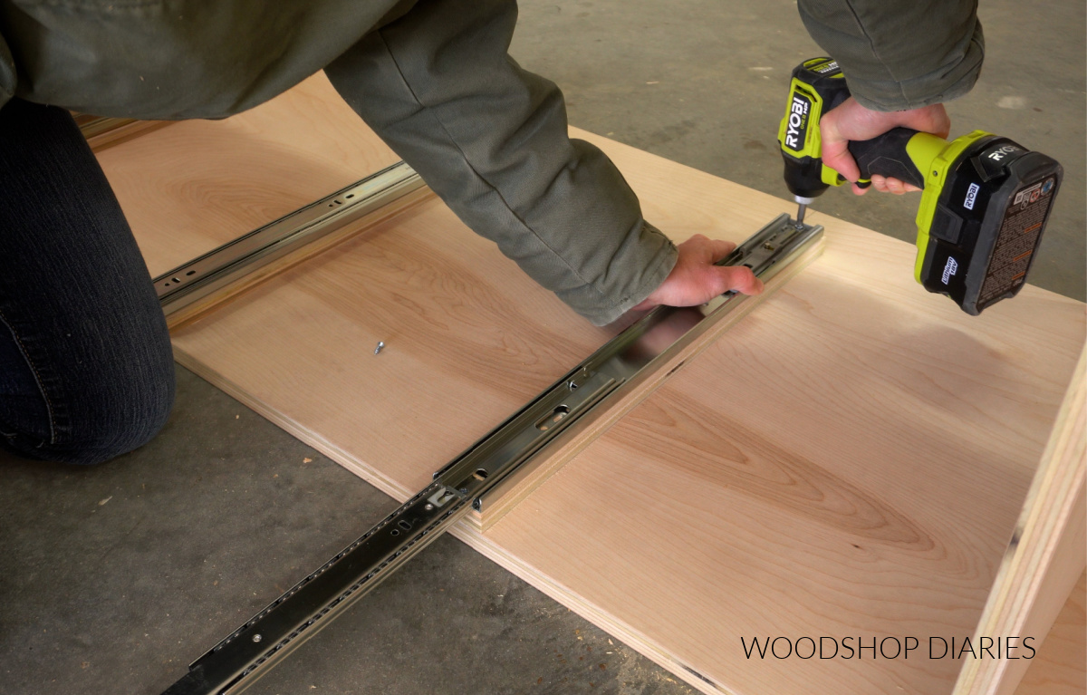 Close up of installing drawer slides for pull out shelves in tall garage cabinet box