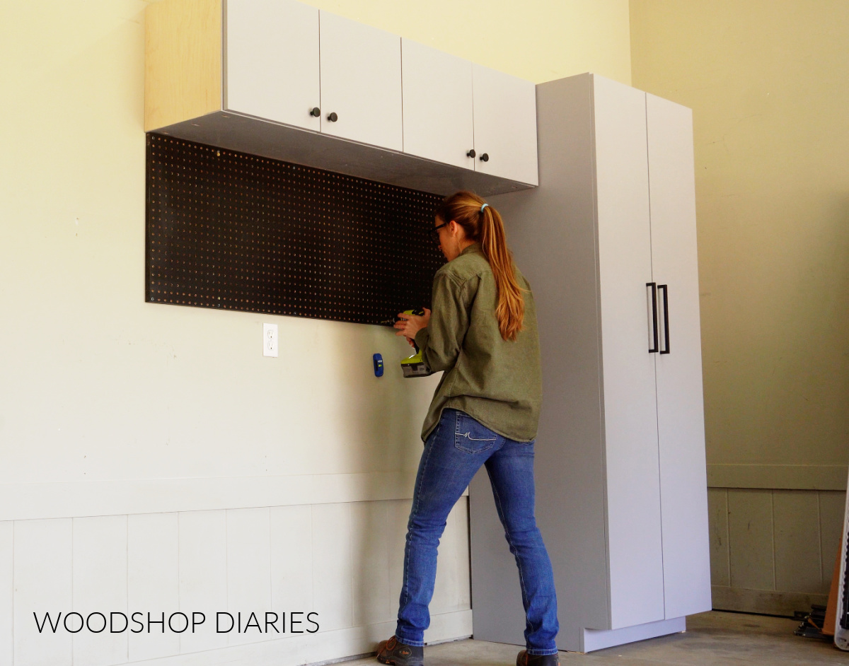 Shara Woodshop Diaries installing peg board panel under upper garage cabinet