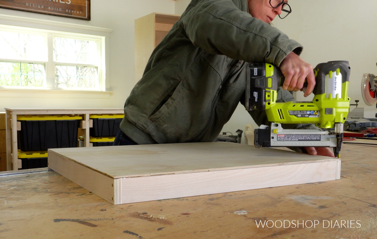 Shara Woodshop Diaries stapling bottom panel onto pull out shelf