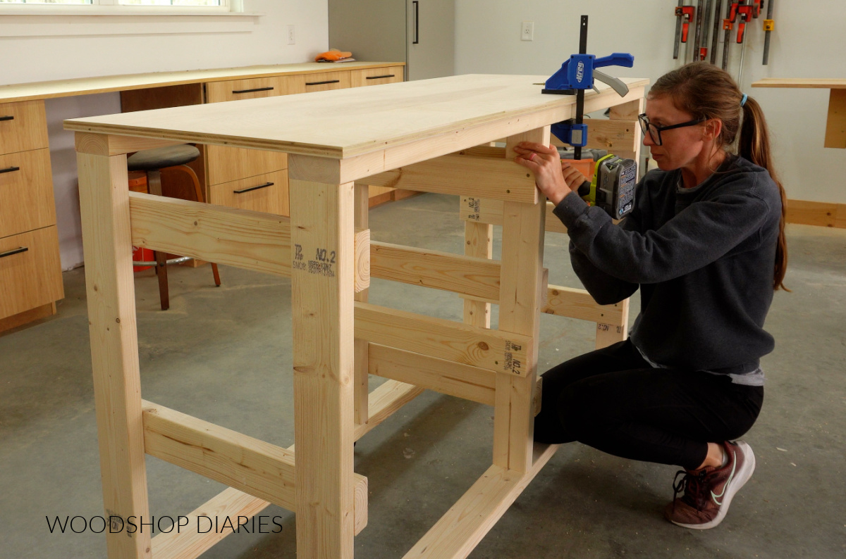 Shara Woodshop Diaries securing ¾" plywood top to workbench frame using screws from the underside of top supports