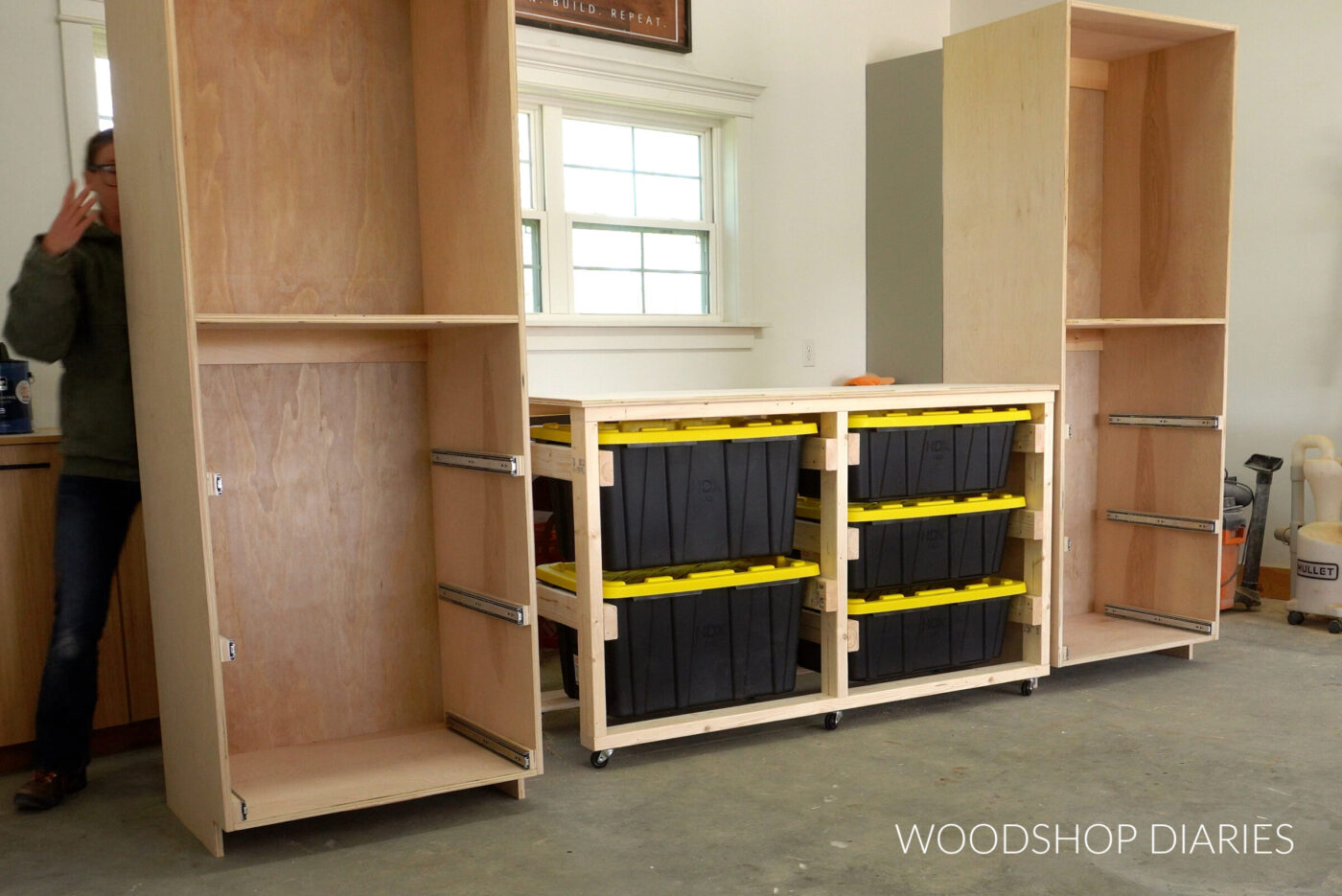 Two tall cabinet boxes with drawer slides on each side of tote storage workbench in Woodshop Diaries workshop